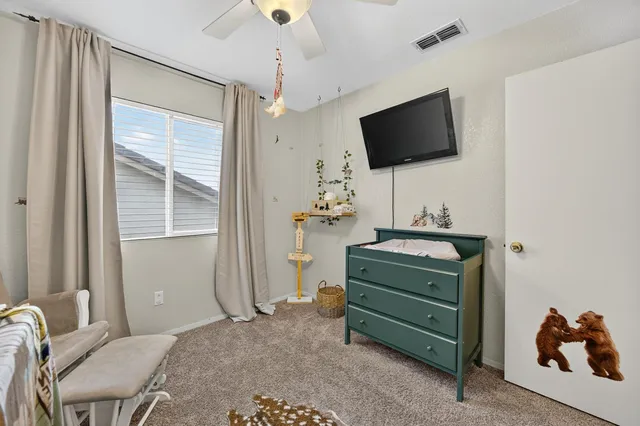 a view of a house with backyard and a tree