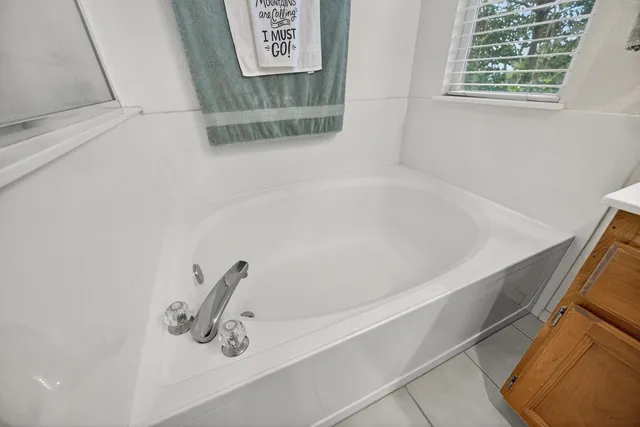 an aerial view of a house with yard and seating space