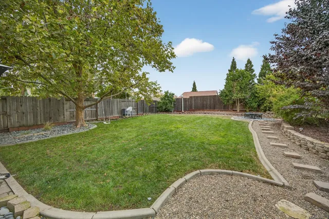 a living room with furniture a ceiling fan and a rug