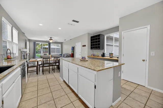 a kitchen with granite countertop a sink and a stove