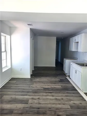 a view of kitchen with granite countertop cabinets and window