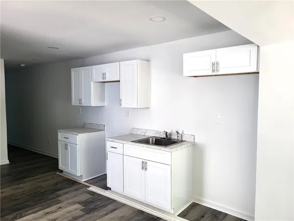 a kitchen with cabinets appliances and a window