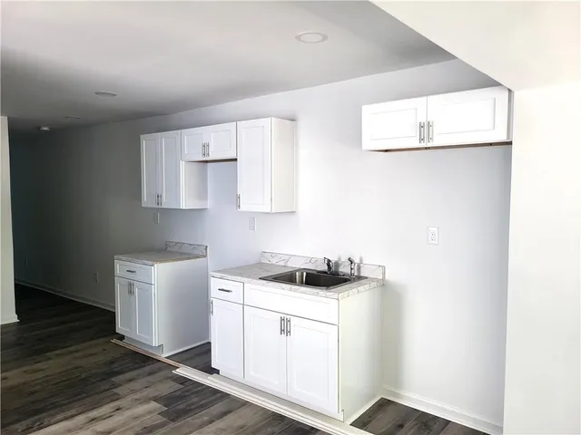 a kitchen with cabinets appliances and a window
