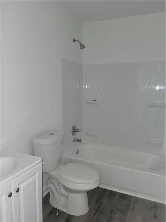a bathroom with a toilet a sink and bathtub