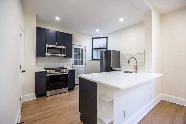 a kitchen with a refrigerator stove and microwave
