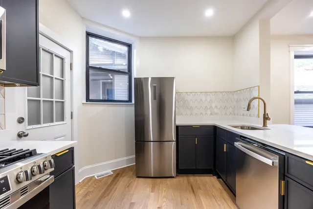 a view of kitchen with microwave and refrigerator