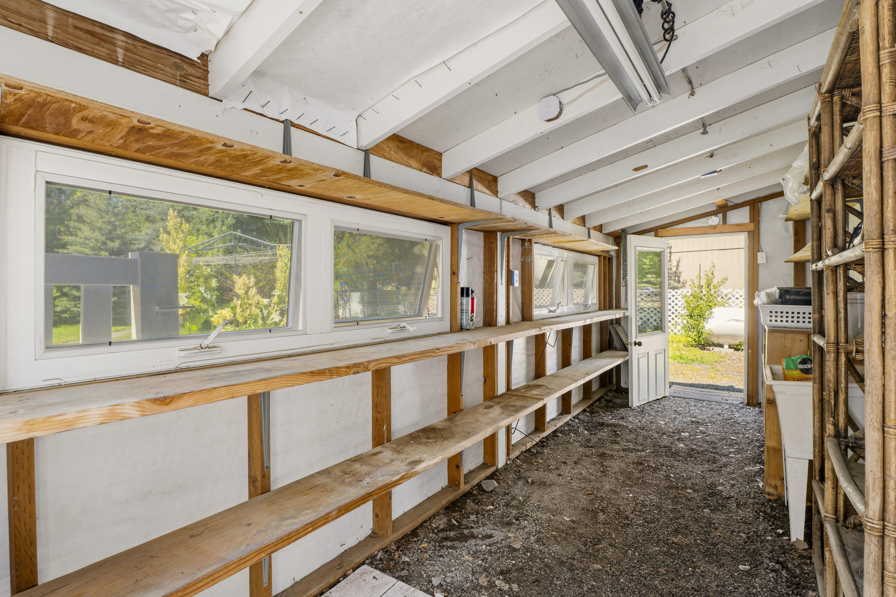 55885 Osprey Road Bend, OR 97707 - Photo 34 of 58 The workspace is located off of the back of garage and seperate from main space. Large windows allow for natural light.
