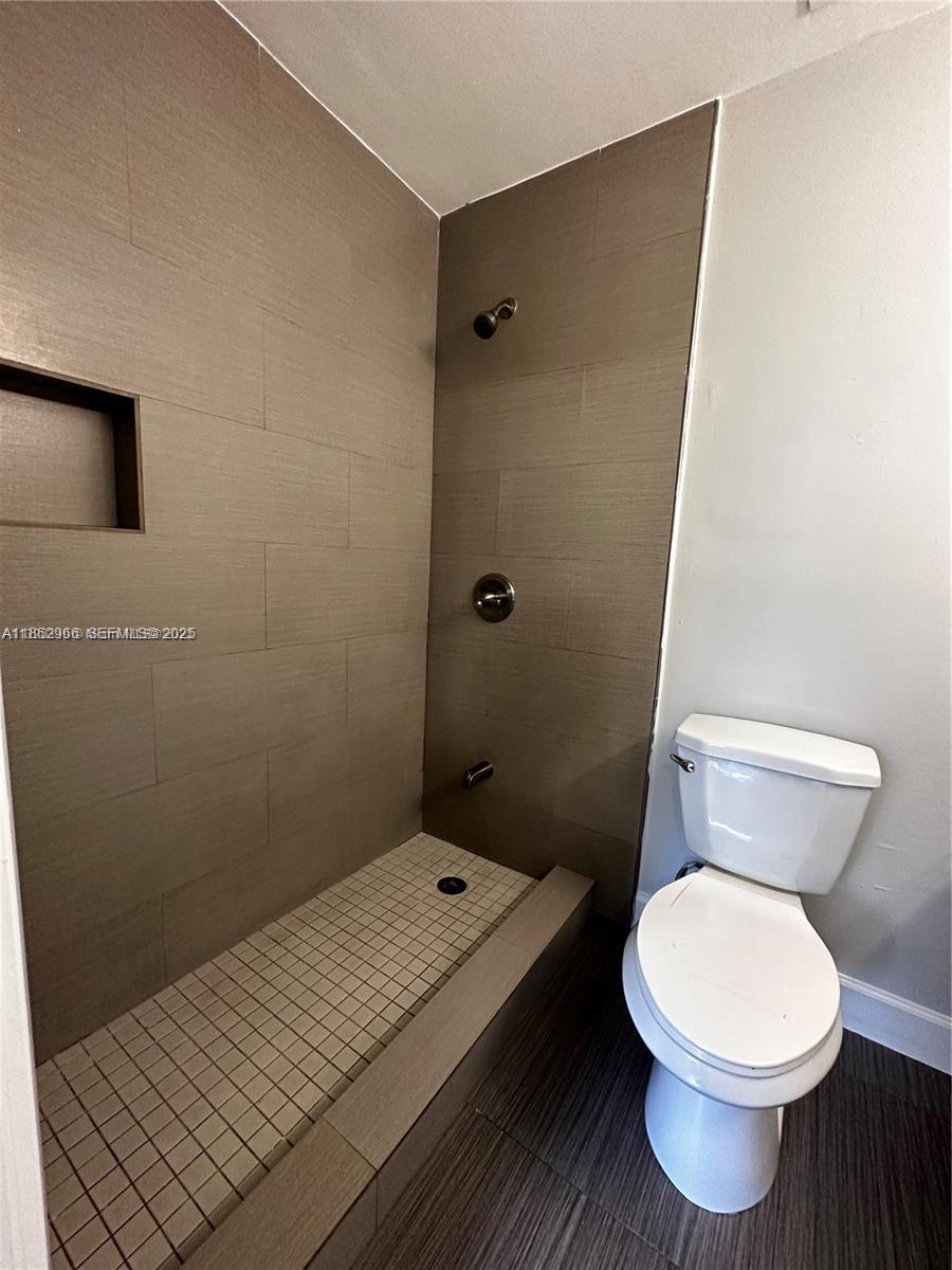 11549 Southwest 4th Street Sweetwater, FL 33174 - Photo 7 of 8 a bathroom with a toilet and a shower