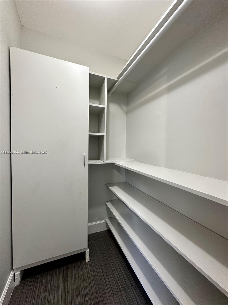 11549 Southwest 4th Street Sweetwater, FL 33174 - Photo 8 of 8 a view of closet with wooden floor