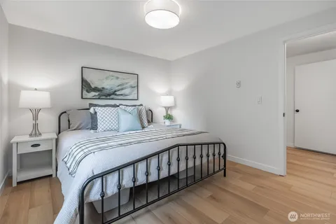 a bedroom with a bed and a painting on the wall