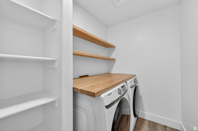 14771 Haddington Road Draper, UT 84020 - Photo 30 of 44 Laundry area featuring a wood-finish countertop, white built-in shelving, and two floating wood-finish shelves