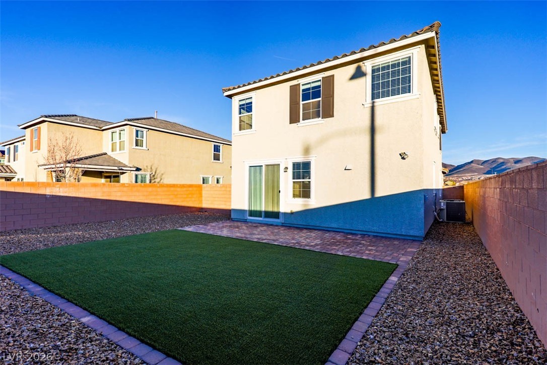 2865 Mincio Street Henderson, NV 89044 - Photo 26 of 33 Back of property with stucco siding, a fenced backyard, and a patio