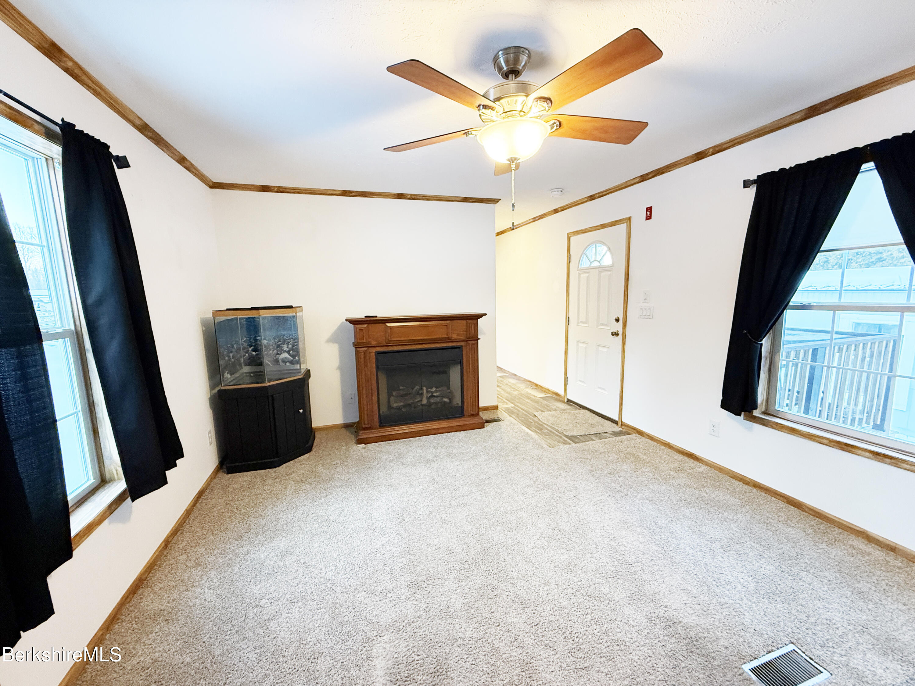405 Pittsfield Road, Unit A6 Lenox, MA 01240 - Photo 6 of 17 a view of an empty room with a fireplace