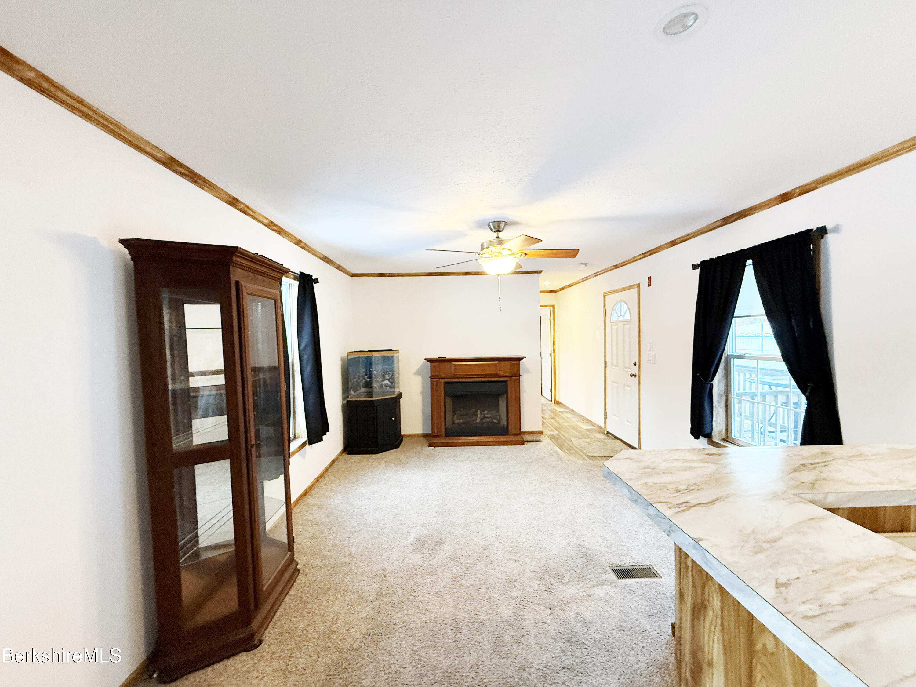 405 Pittsfield Road, Unit A6 Lenox, MA 01240 - Photo 7 of 17 a view of a kitchen with furniture and a fireplace