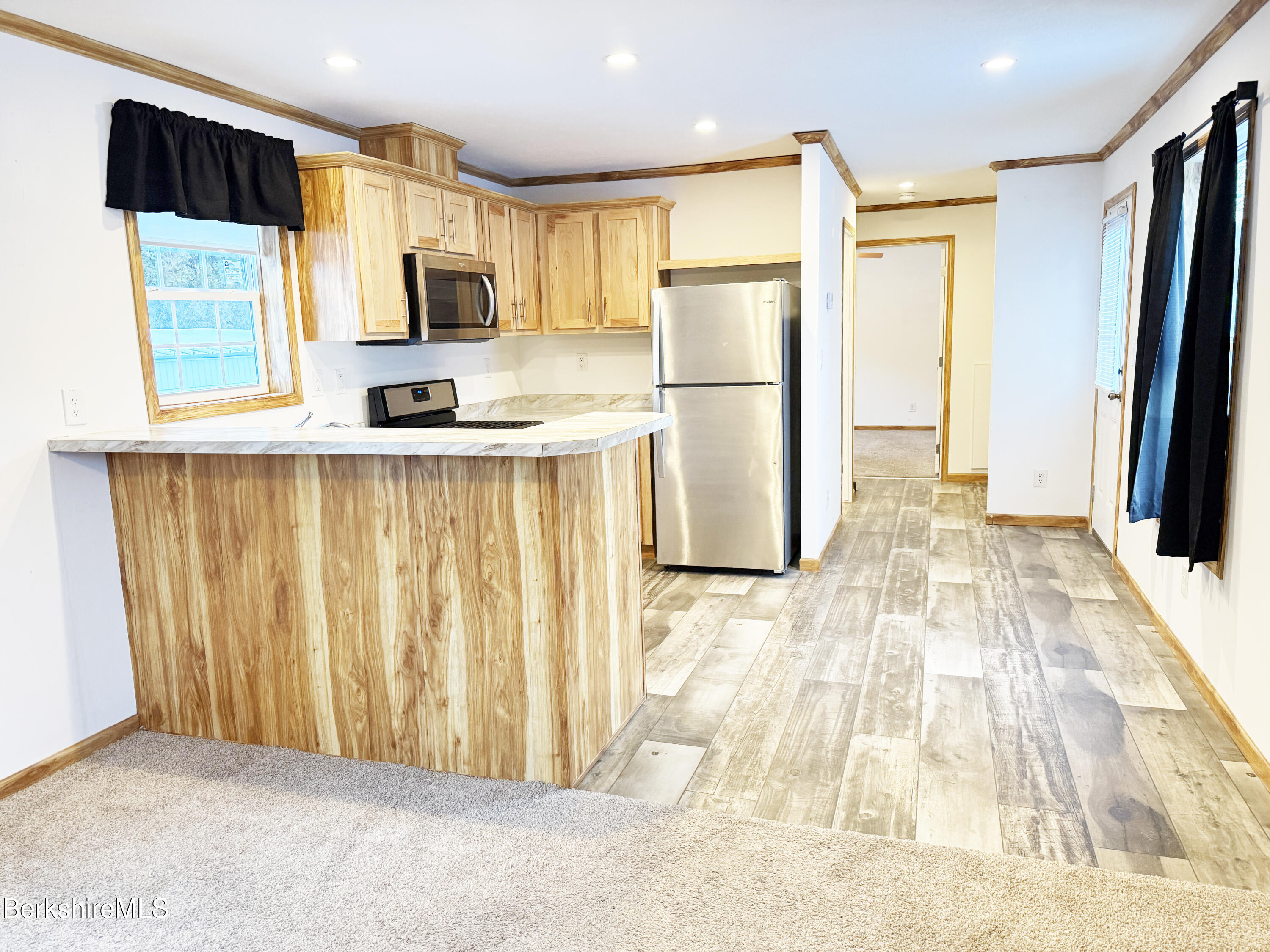405 Pittsfield Road, Unit A6 Lenox, MA 01240 - Photo 8 of 17 a kitchen with stainless steel appliances a refrigerator and a stove top oven