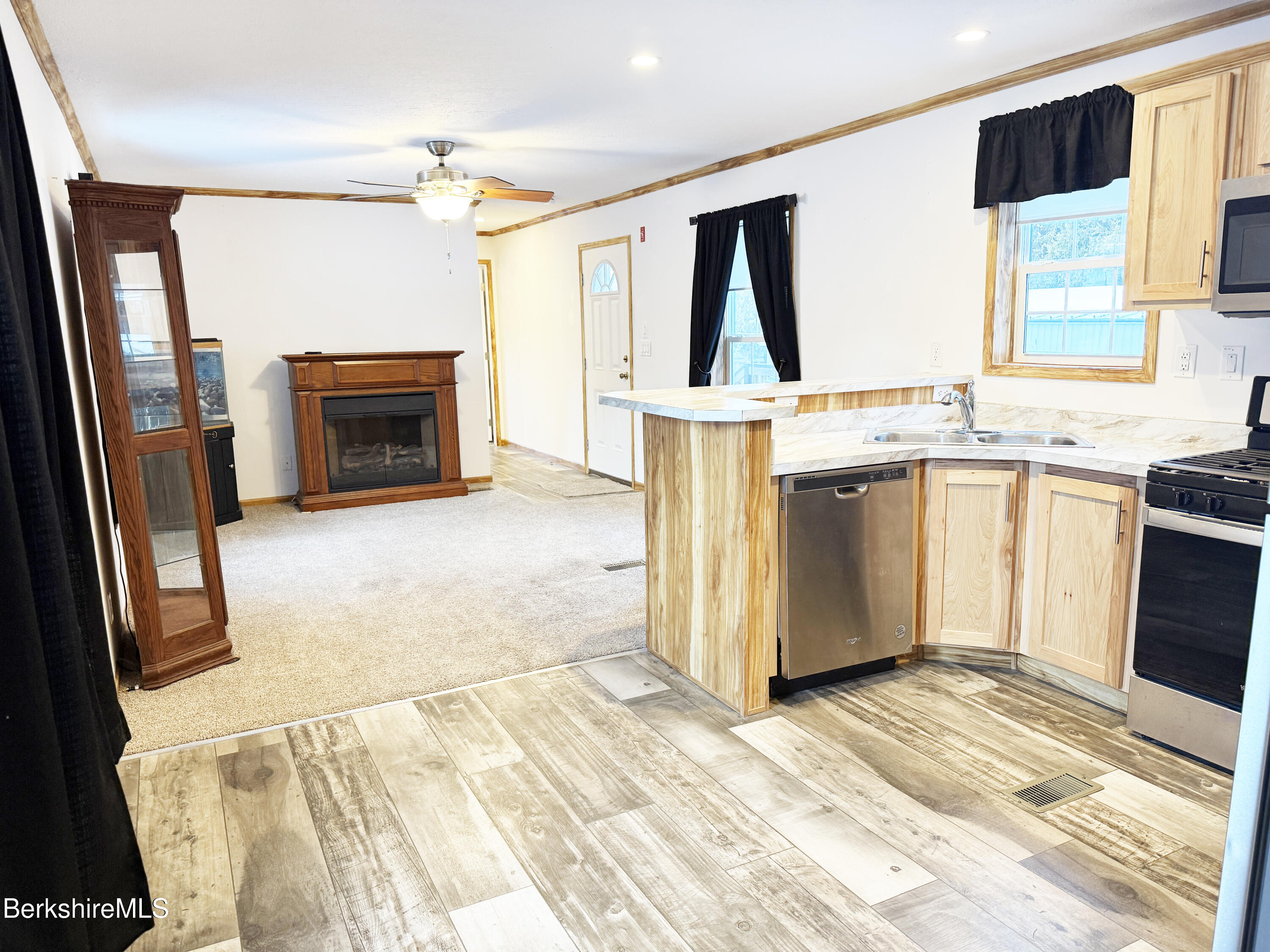 405 Pittsfield Road, Unit A6 Lenox, MA 01240 - Photo 9 of 17 a kitchen with stainless steel appliances a stove a sink and a refrigerator