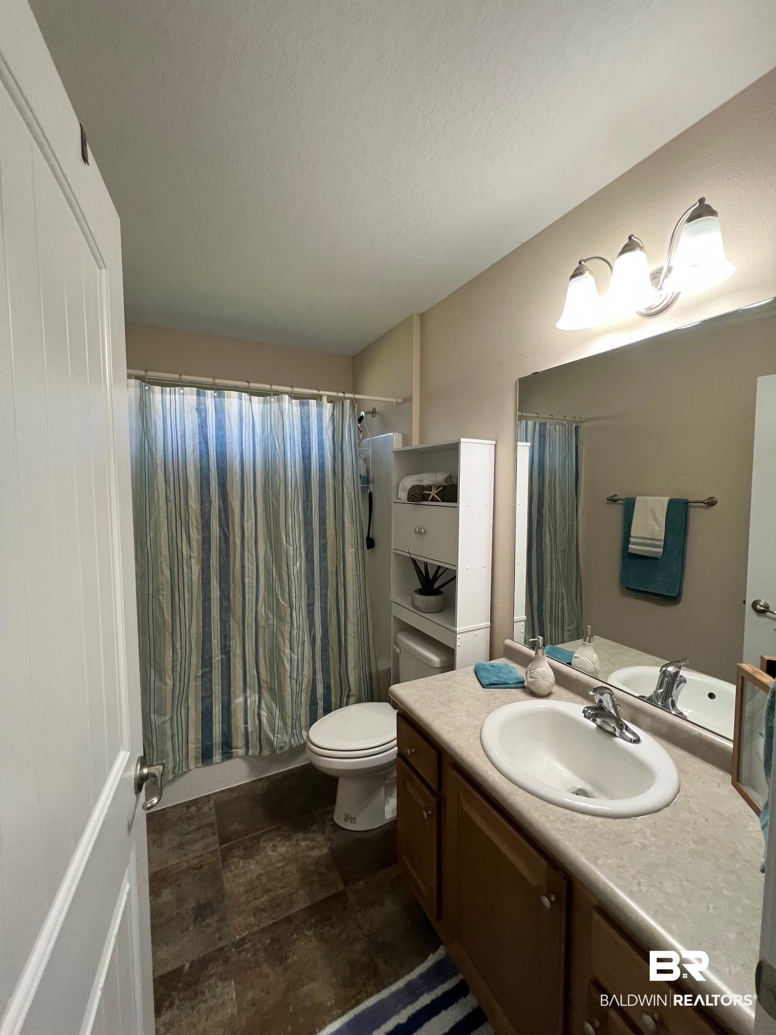 10257 Lyttleton Loop Lillian, AL 36549 - Photo 22 of 31 Bathroom featuring vanity and shower / bathtub combination with curtain