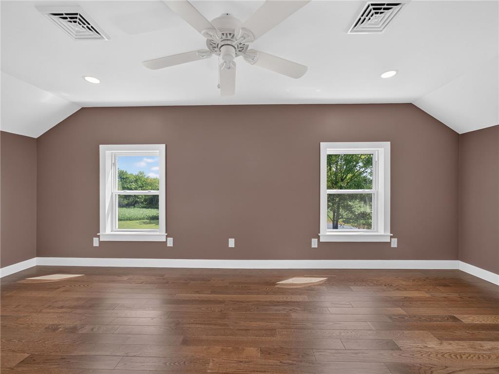 291 East Dannersville Road Bath, PA 18014 - Photo 40 of 46 Rich hardwood flooring complements the deep wall tones in this spacious room, illuminated by natural light and recessed lighting.