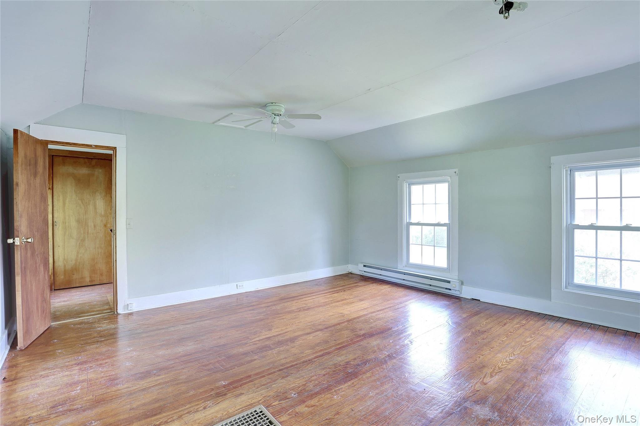 500 Haverstraw Road Suffern, NY 10901 - Photo 21 of 36 an empty room with wooden floor and windows