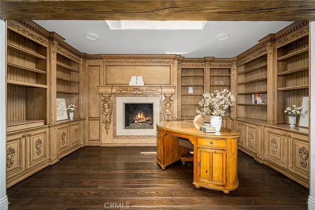 a dining hall with stainless steel appliances granite countertop a stove and a wooden floors