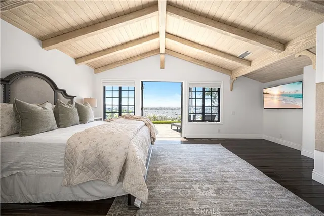 a bedroom with bed and wooden floor