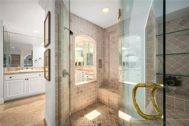 a spacious bathroom with a tub shower and mirror
