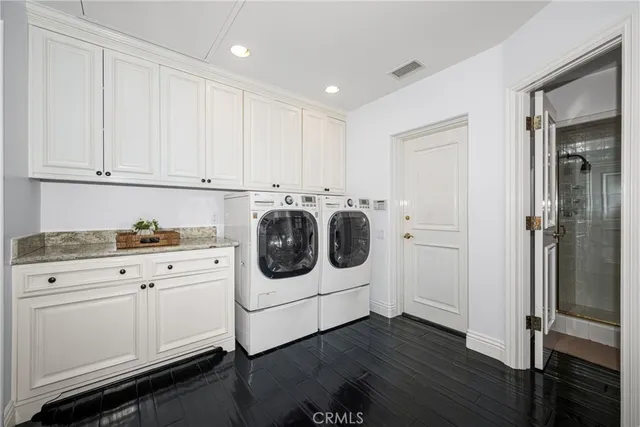 a kitchen with a refrigerator and white cabinets