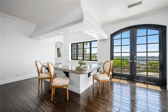 a dining room with wooden floor a chandelier