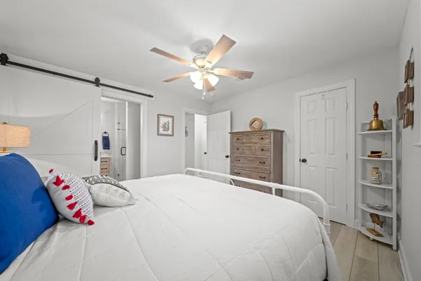 a bedroom with a bed and a chandelier