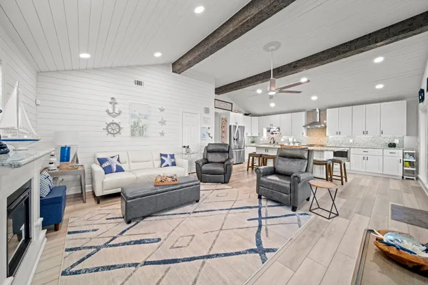 a living room with furniture and kitchen view