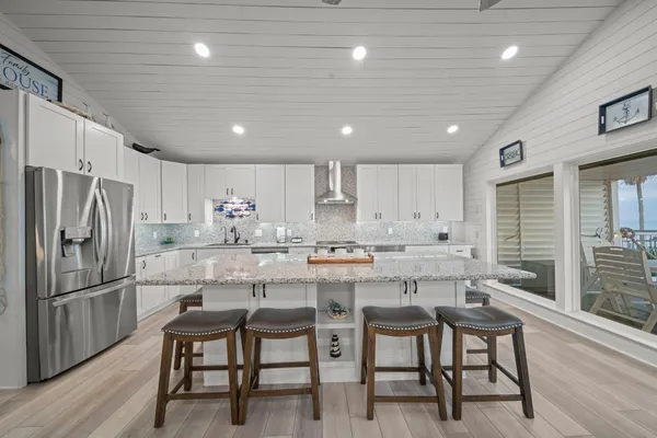 a large kitchen with granite countertop lots of counter space and sink