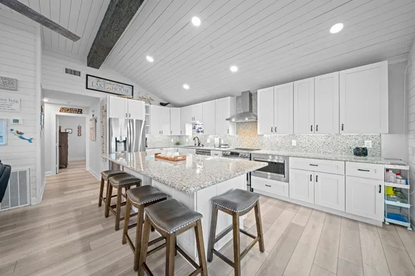 a kitchen with stainless steel appliances granite countertop lots of counter top space and furniture