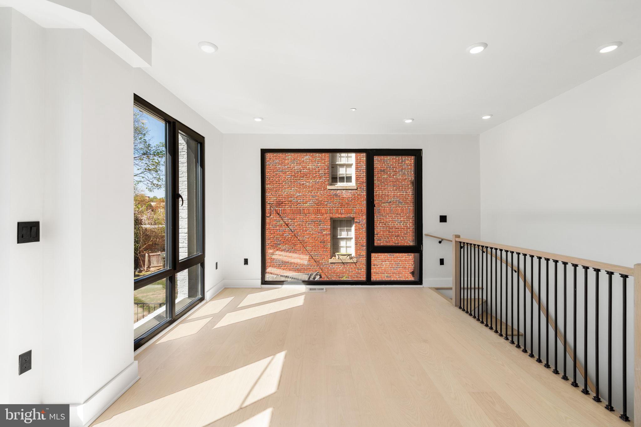 2504 41st Street Northwest, Unit 3 Washington, DC 20007 - Photo 8 of 24 a view of a room with large windows and a table