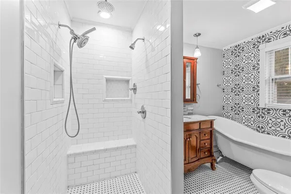 a bathroom with a sink toilet and shower