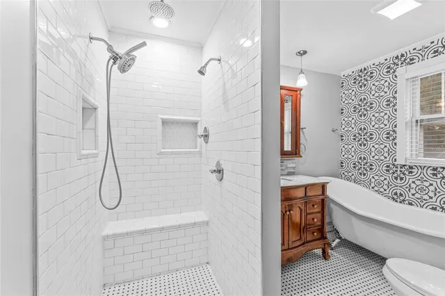 a bathroom with a sink toilet and shower