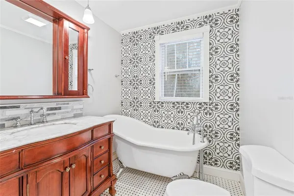 a bathroom with a sink a toilet and a bathtub