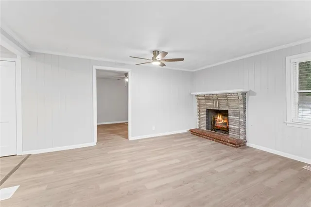 an empty room with fireplace and fan