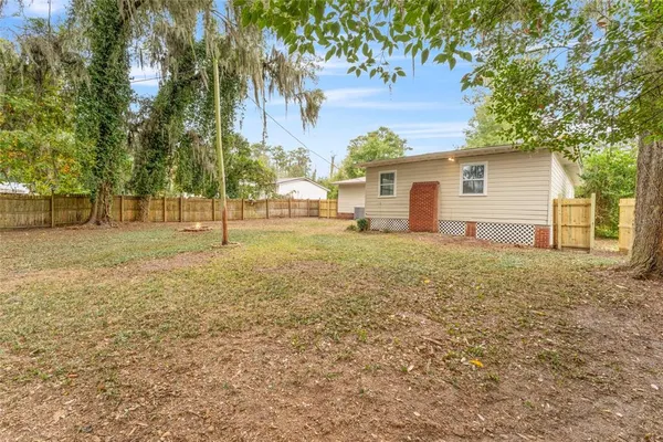 a view of a yard with a house and tree s