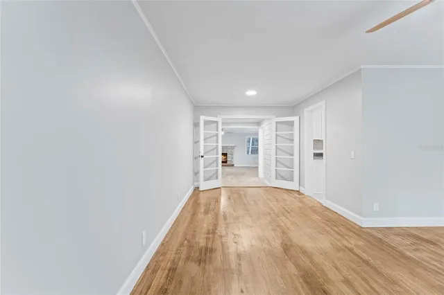 a view of empty room with wooden floor