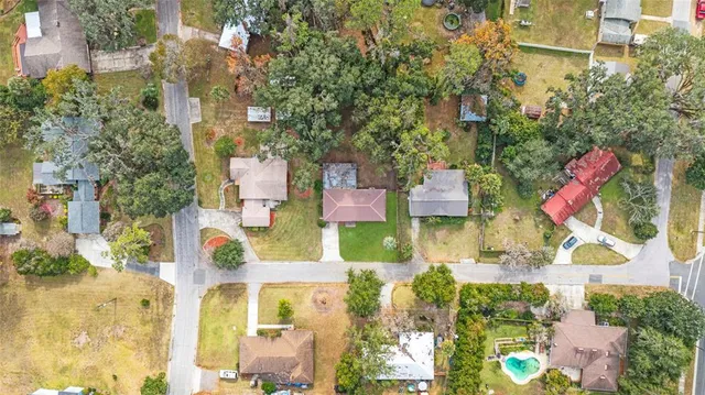 an aerial view of residential houses with outdoor space and street view