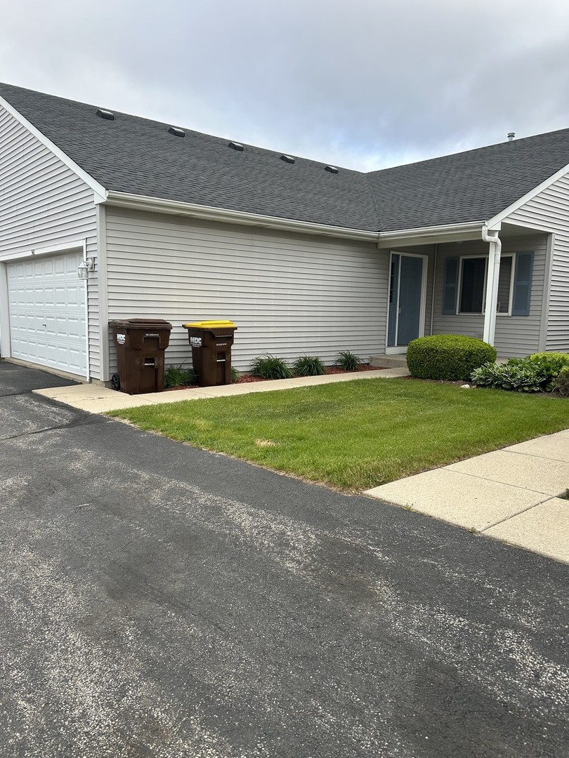 a view of a house with a yard and garage