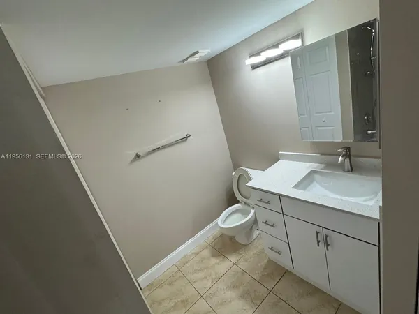 a bathroom with a sink a toilet and a mirror