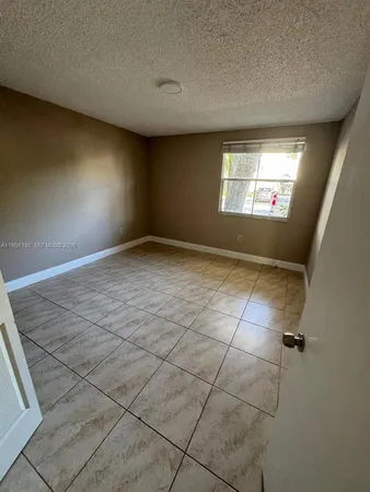 a view of an empty room and a window