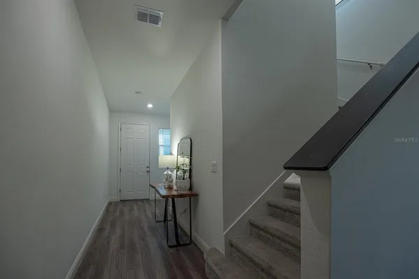 a view of entryway and hall with wooden floor