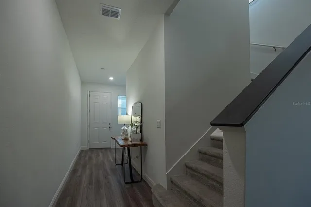 a view of entryway and hall with wooden floor