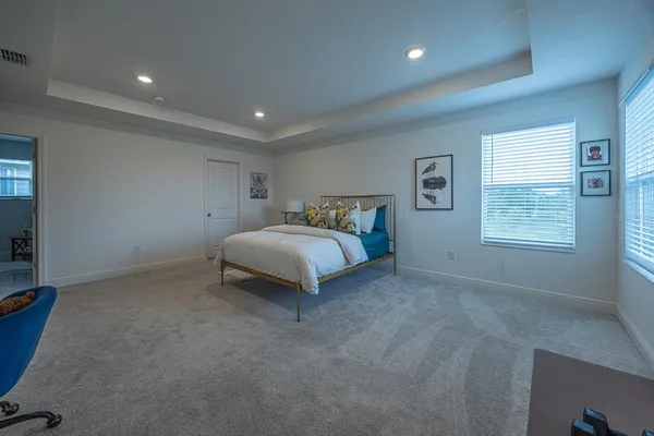 a spacious bedroom with a bed and a window