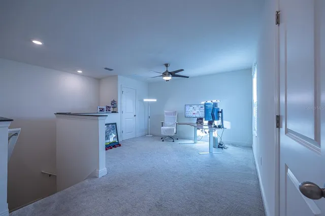 a view of a livingroom and a kitchen with a sink cabinets and rug floor