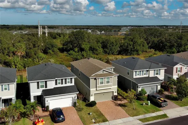 an aerial view of multiple houses with a yard