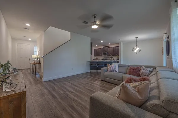 a living room with furniture and kitchen view