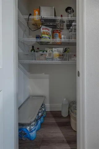 a room with water heater and wooden cabinets
